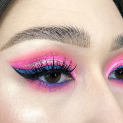 A woman wearing blue and pink eyeshadow