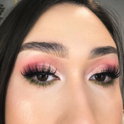 A woman wearing pink and green eyeshadow
