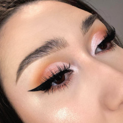 A woman wearing a blend of pink and orange eyeshadow