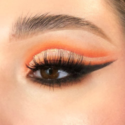 A woman wearing a blend of orange eyeshadow