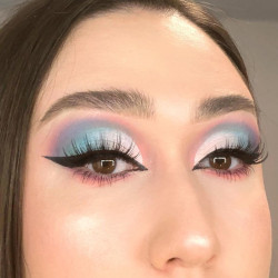 A woman wearing a blend of pastel coloured eyeshadow
