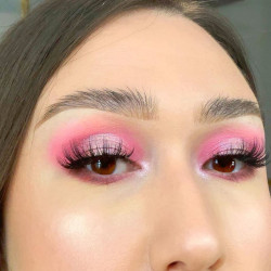 A woman wearing pink eyeshadow